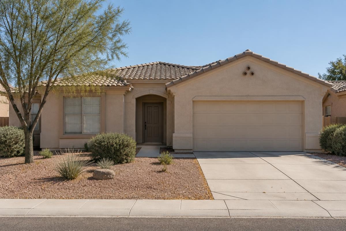 A single-storey stucco house with a concrete tile roof and desert gravel landscaping on a Phoenix-area street